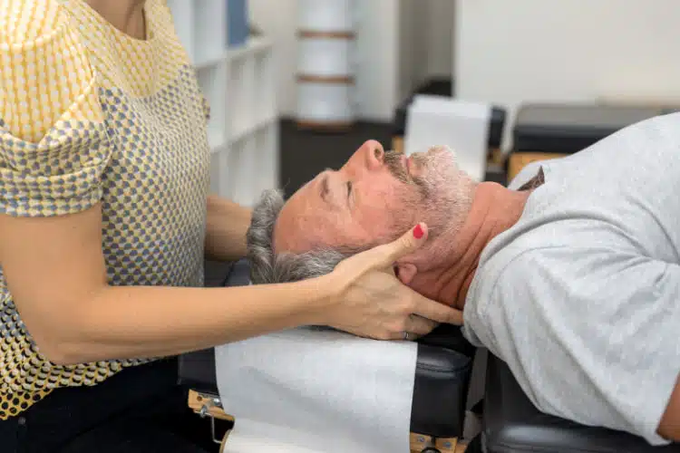 Chiropractor conducting post car accident treatment on a patients neck