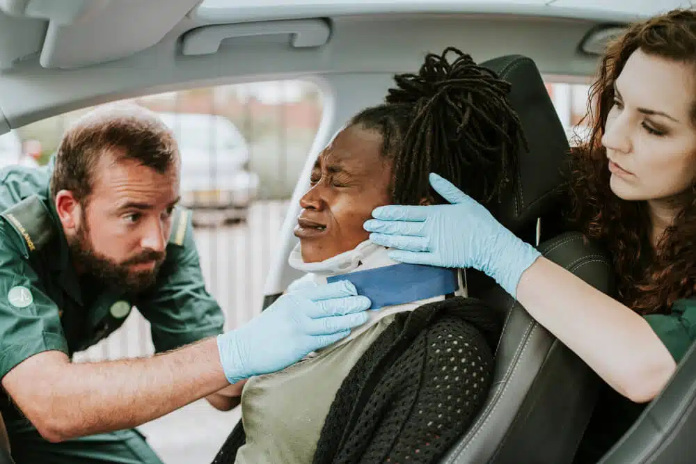 A woman with a car accident experiencing a physical trauma